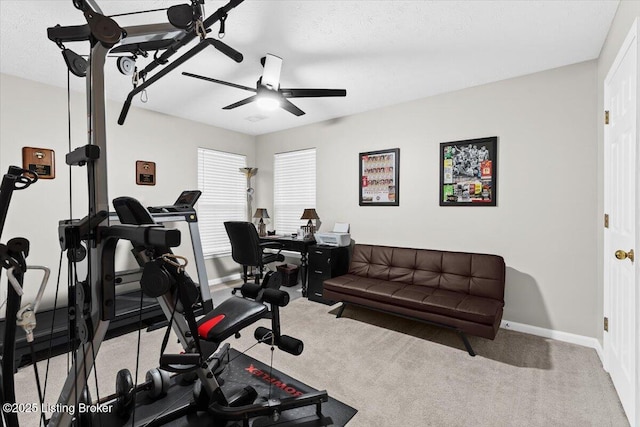 exercise area with ceiling fan and carpet