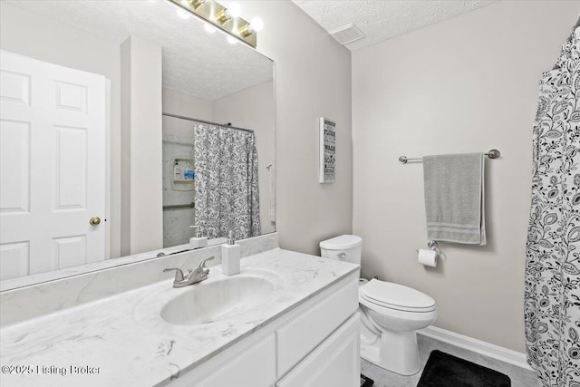 bathroom featuring vanity, toilet, and a textured ceiling