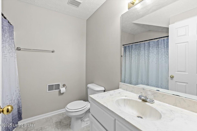 bathroom with vanity, a textured ceiling, and toilet