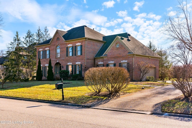 view of property featuring a garage and a front yard