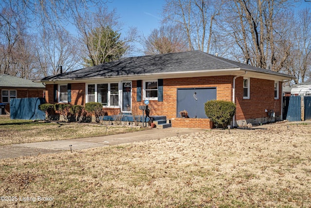 single story home with roof with shingles, brick siding, a front lawn, and fence