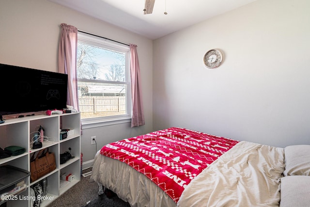 carpeted bedroom featuring a ceiling fan and baseboards