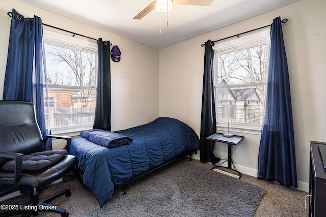 bedroom with carpet floors, multiple windows, a ceiling fan, and baseboards