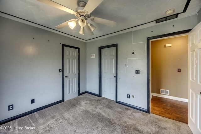 unfurnished bedroom with carpet floors, a closet, visible vents, and baseboards