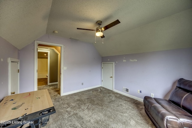 bonus room with baseboards, visible vents, lofted ceiling, carpet, and a textured ceiling