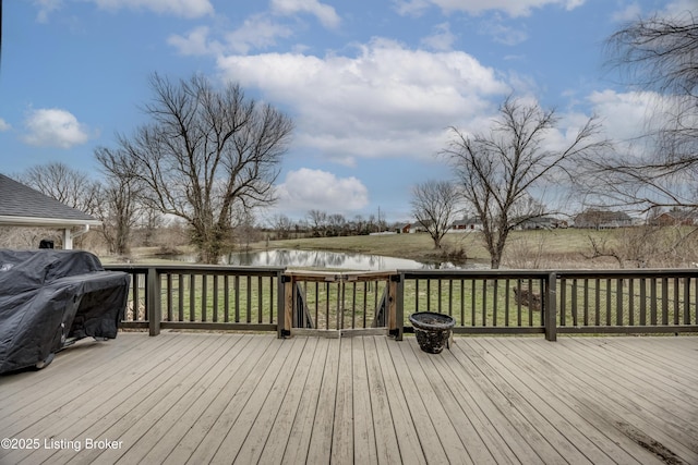 deck with grilling area and a water view