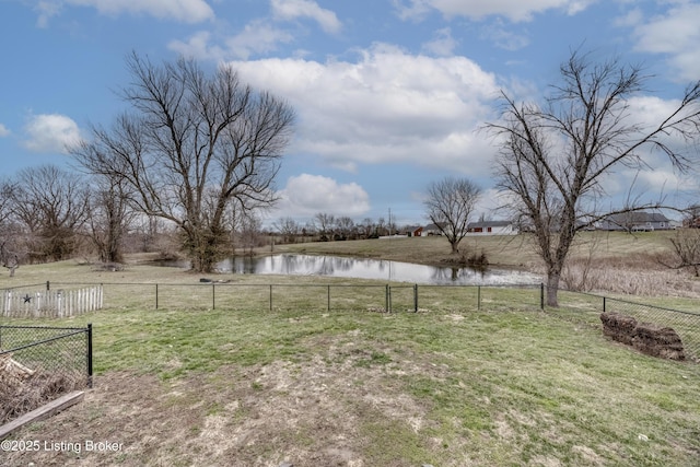 view of yard with a water view and fence