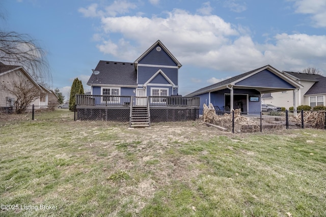 rear view of property with fence, a wooden deck, and a lawn