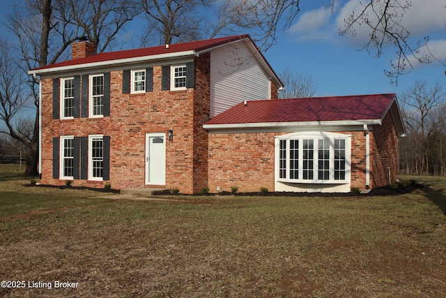 colonial-style house with a front yard