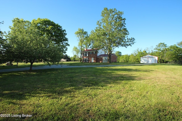 1472 Mulberry Pike, Eminence, KY 40019 - view of grassy yard featuring a detached garage, a storage unit, and an outbuilding