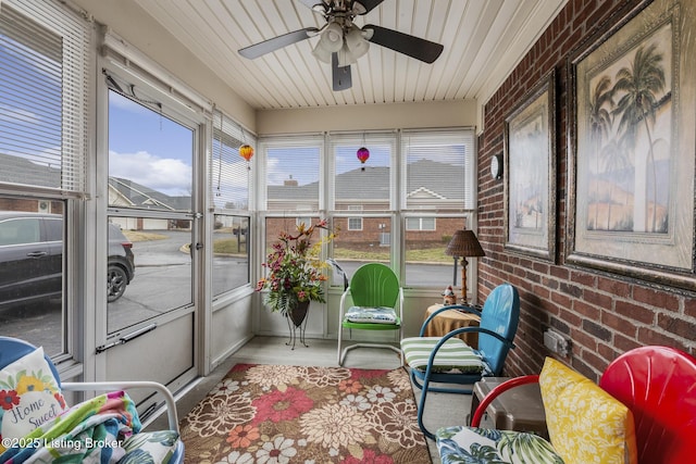 sunroom / solarium featuring ceiling fan