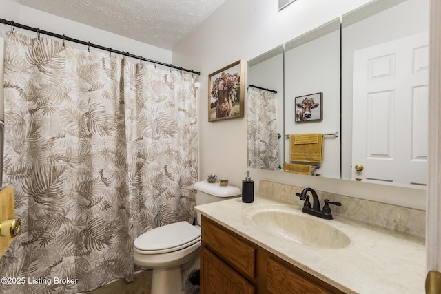 bathroom featuring vanity, a textured ceiling, and toilet