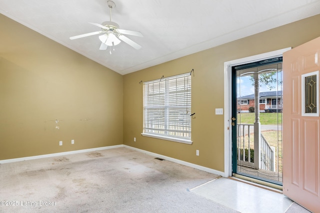 doorway with lofted ceiling, light colored carpet, and ceiling fan