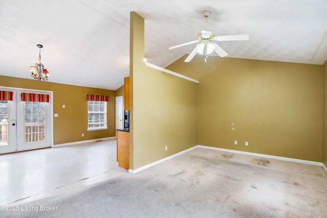 unfurnished living room with french doors, ceiling fan with notable chandelier, vaulted ceiling, and a textured ceiling