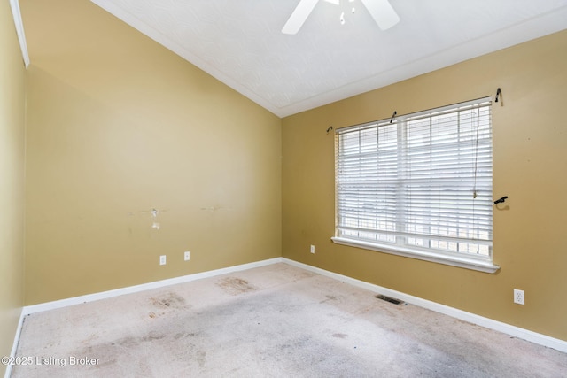 carpeted empty room with vaulted ceiling and ceiling fan