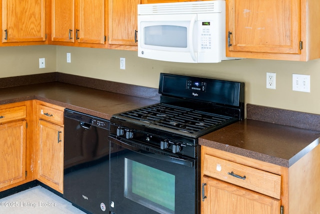 kitchen with light tile patterned floors and black appliances