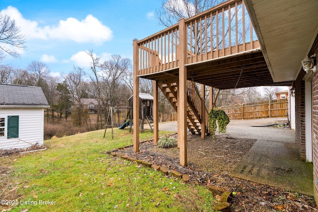 view of yard with a playground and a deck