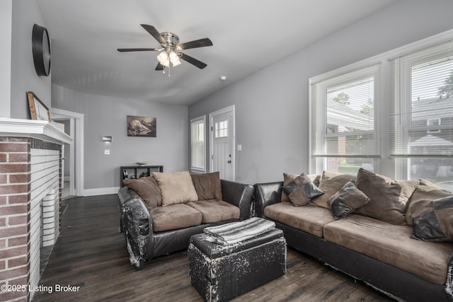 living room featuring ceiling fan, a fireplace, and dark hardwood / wood-style flooring