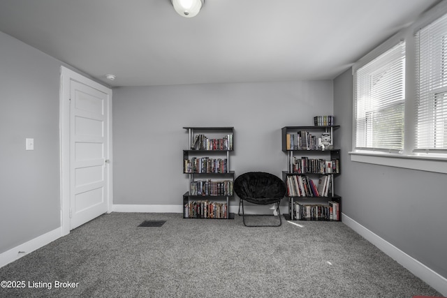 living area featuring carpet