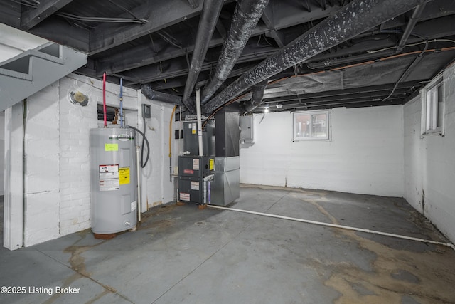 basement with heating unit, electric panel, and water heater