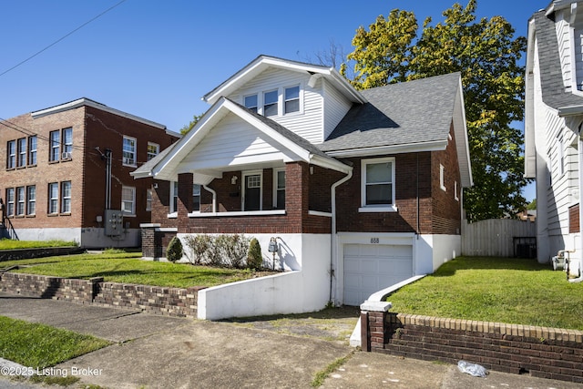 view of front of house featuring a garage and a front lawn