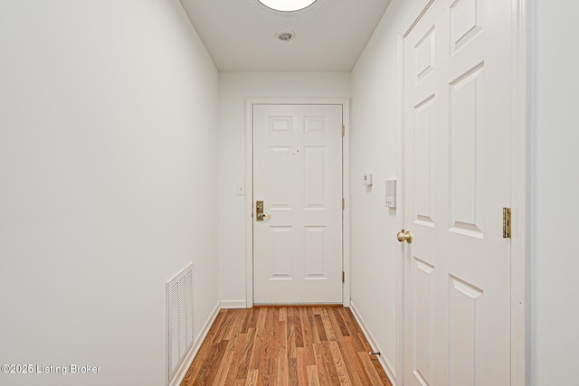 doorway to outside with light wood-type flooring