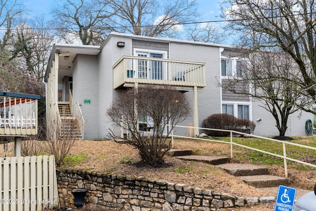 view of front of property featuring a balcony