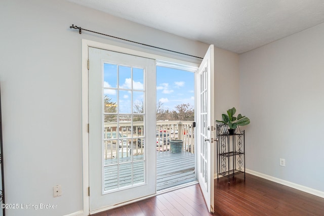 doorway to outside featuring french doors, dark hardwood / wood-style flooring, and a textured ceiling