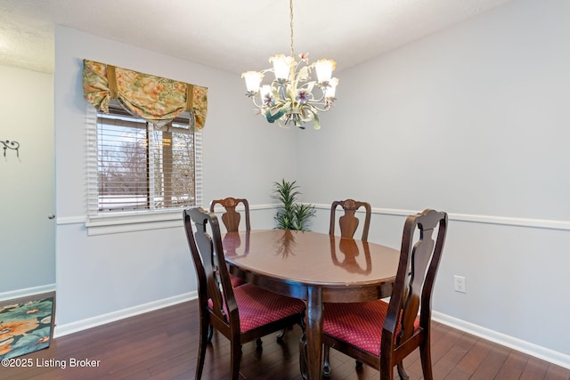 dining room featuring dark hardwood / wood-style floors and a notable chandelier