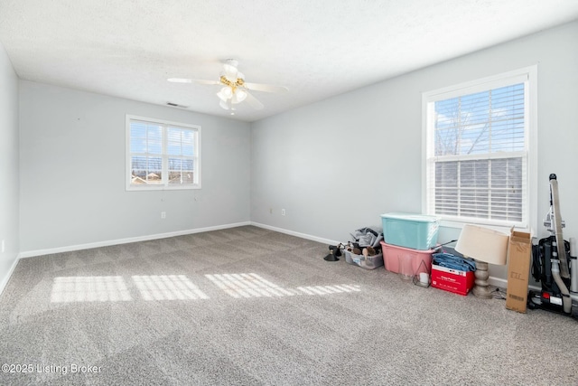 carpeted empty room featuring a textured ceiling and ceiling fan