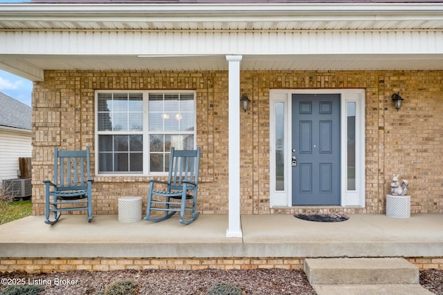 entrance to property with central air condition unit and a porch