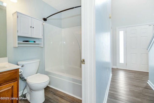 full bathroom with toilet, wood-type flooring,  shower combination, and vanity