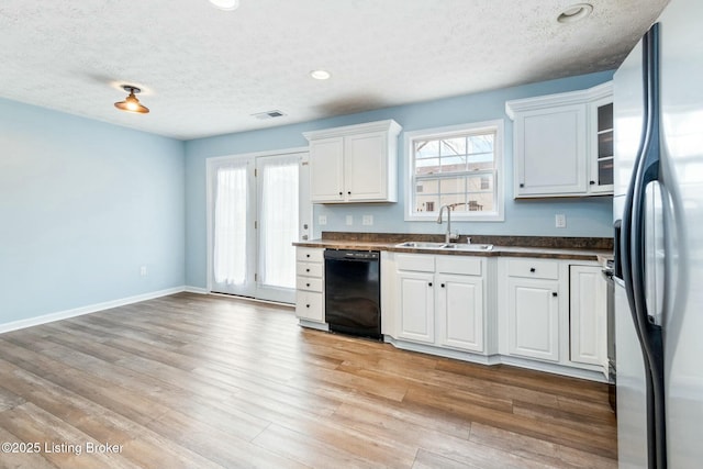 kitchen with sink, white cabinets, dishwasher, and stainless steel refrigerator with ice dispenser