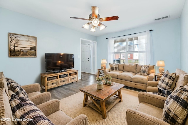 living room with hardwood / wood-style floors and ceiling fan