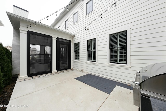 view of patio featuring a grill