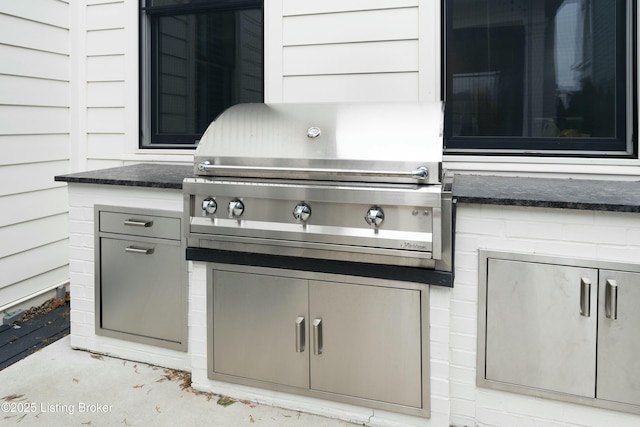 view of patio / terrace with exterior kitchen and a grill