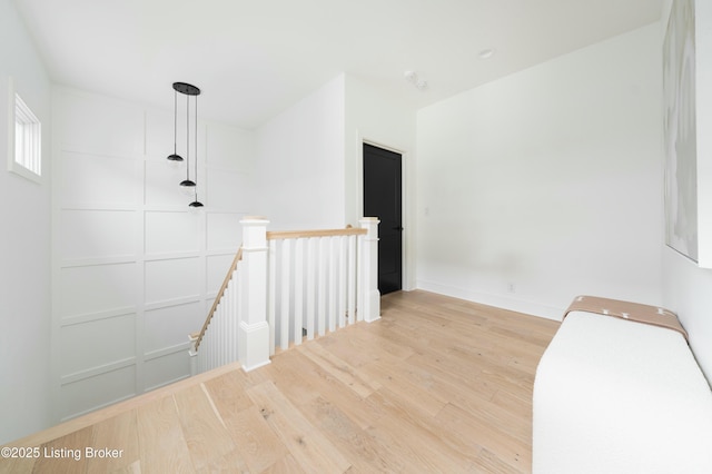 corridor with light hardwood / wood-style flooring