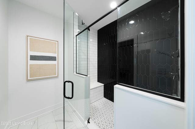 bathroom with a shower with door