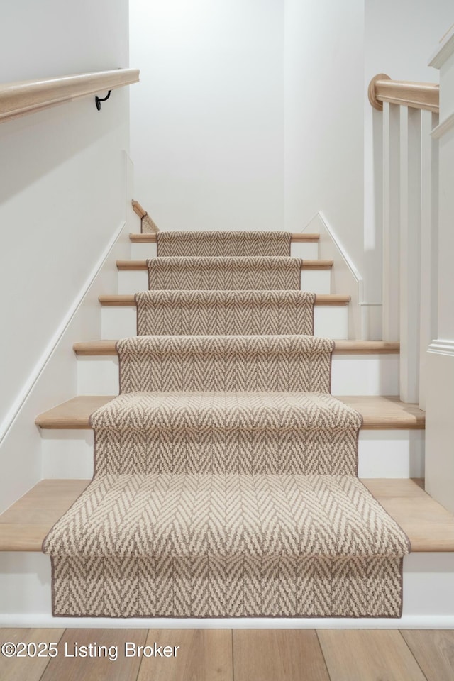 stairs with hardwood / wood-style flooring