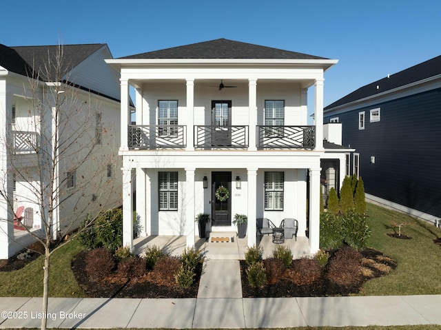 view of front of house with a balcony and covered porch