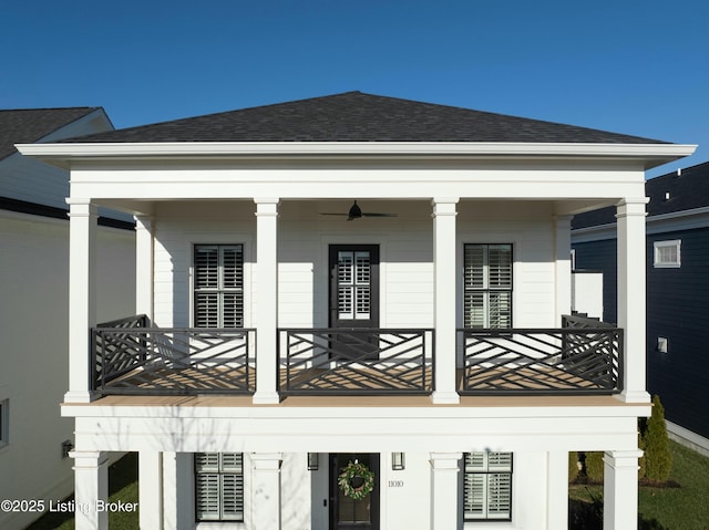 rear view of house featuring a porch and a balcony