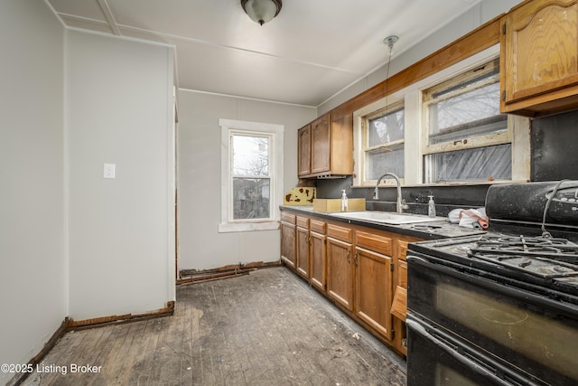 114 E Norwood Ave, Clarksville, IN 47129 - kitchen with range with two ovens, sink, dark wood-type flooring, and decorative light fixtures