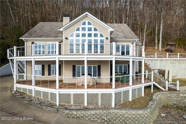 rear view of property with a balcony