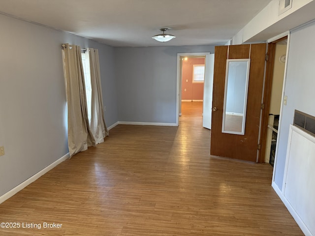 unfurnished room with light wood-type flooring