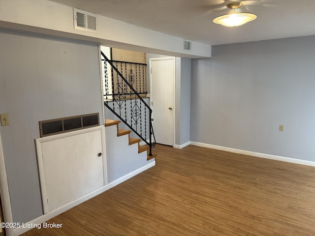 basement with hardwood / wood-style flooring