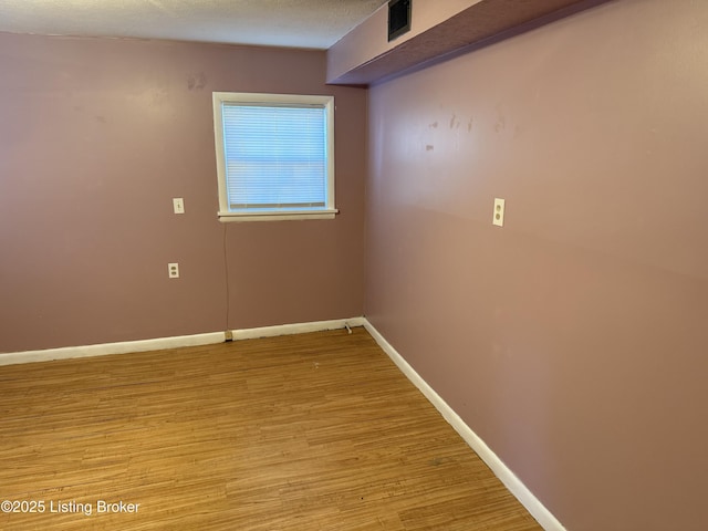 spare room featuring light hardwood / wood-style floors