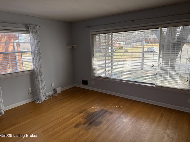 unfurnished room with hardwood / wood-style flooring