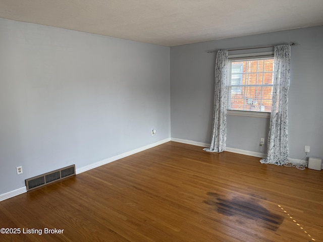 empty room with wood-type flooring