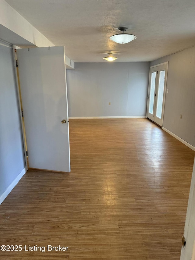 unfurnished room featuring hardwood / wood-style floors and a textured ceiling