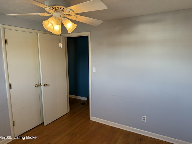 unfurnished bedroom with ceiling fan, wood-type flooring, and a closet